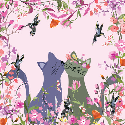 Two cats in a floral setting with hummingbirds