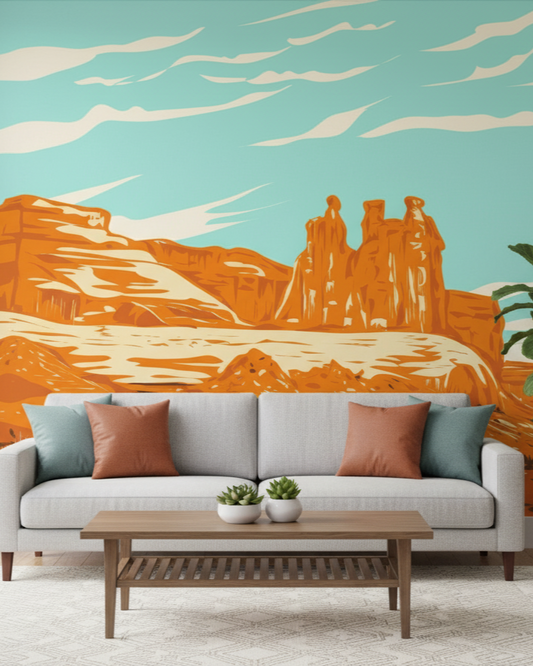 Living room with a couch, coffee table, and wall mural of desert landscape.