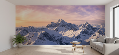 Living room with a large wall mural of snow-covered mountains.