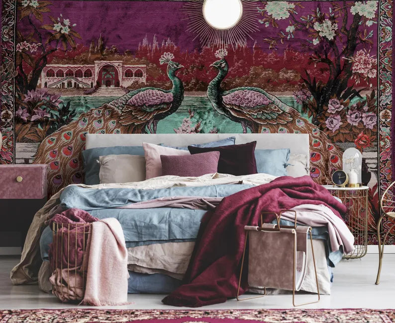 Decorative bedroom with peacock tapestry, colorful bedding, and a side table.