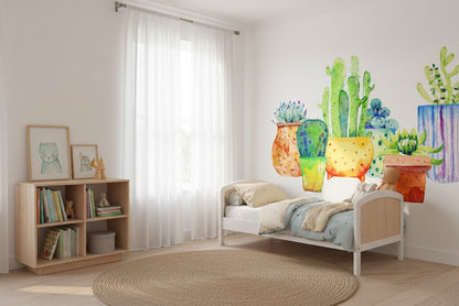Children's room with a bed, bookshelf, and wall decal of colorful cacti.