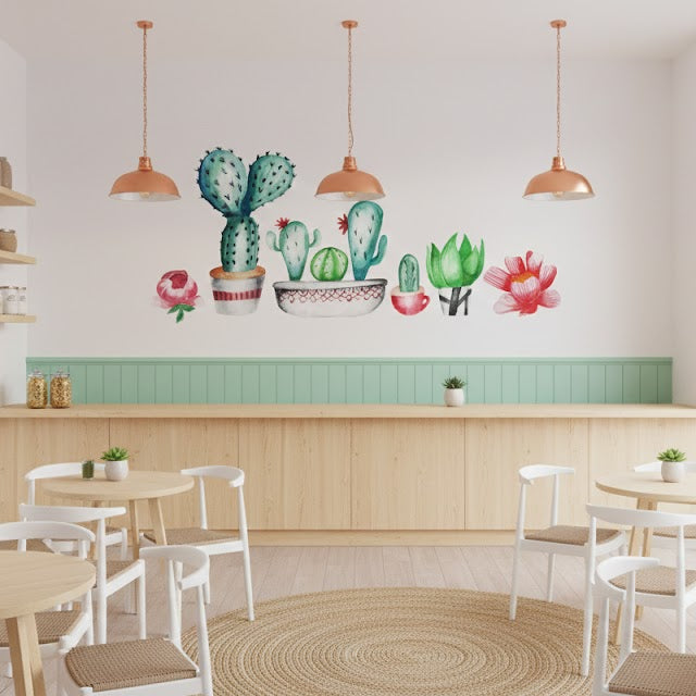 Cactus-themed cafe interior with cacti wall art and wooden furniture.